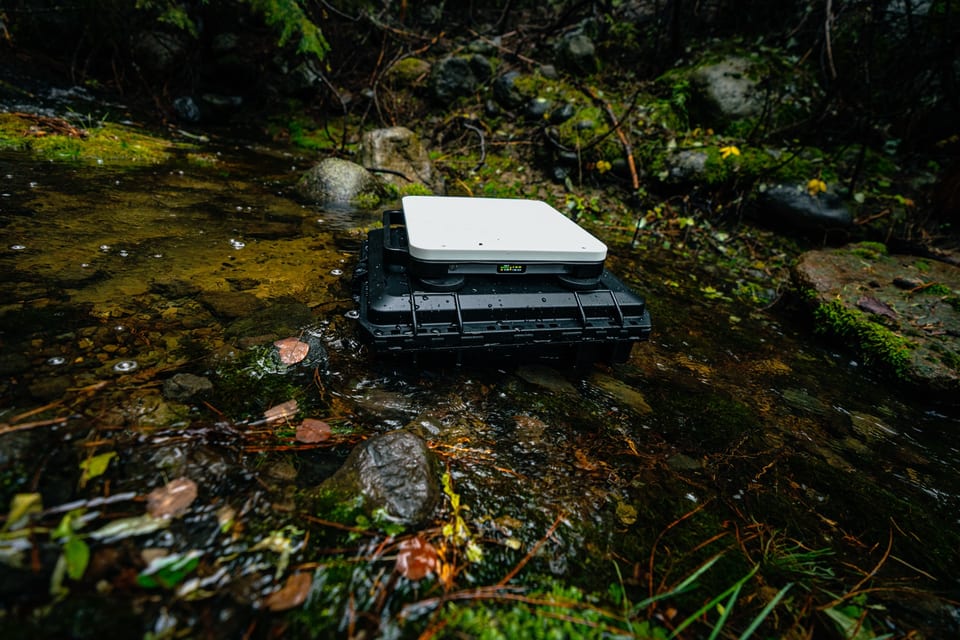 Portable battery powering Starlink Mini at a campsite